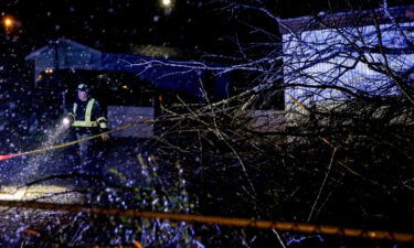 Emergency personnel survey a damaged mobile home after a possible tornado passed through on February 17 in Leeds