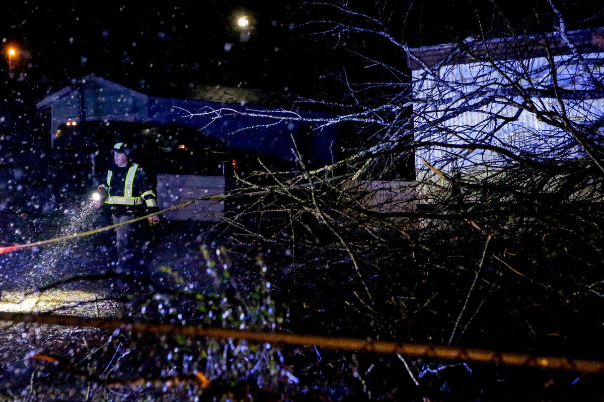 <i>Butch Dill/AP</i><br/>Emergency personnel survey a damaged mobile home after a possible tornado passed through on February 17 in Leeds