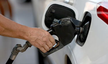 A customer pumps gas into his vehicle at a Shell station in 2021 in Miami.