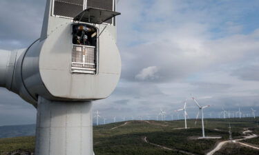 Employees from Akfen Renewable Energy Group's Canakkale Wind Power Plant in Turkey do a routine maintenance check of equipment on the top of a wind turbine in December 2021.