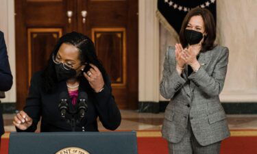 Flanked by President Joe Biden and Vice President Kamala Harris