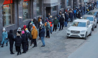 People stand in line to use an ATM money machine in Saint Petersburg