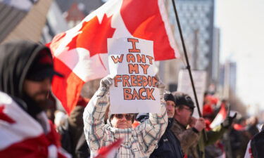 A demonstrator holds a sign during a protest against mandates related to Covid-19 vaccines and restrictions in downtown Toronto on February 5