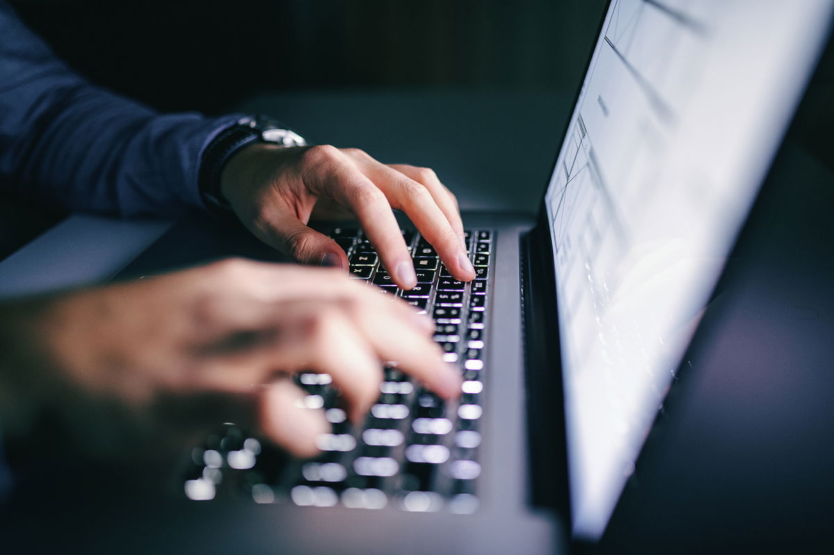 <i>Adobe Stock</i><br/>Close up of hands typing on laptop.