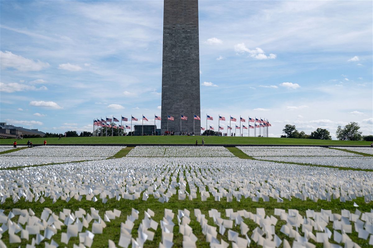 <i>Kent Nishimura/Los Angeles Times/Getty Images</i><br/>The Washington monument sits as a backdrop to the 'In America: Remember' public art installation near on the National Mall in 2021 in Washington