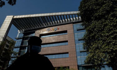 A man is silhouetted as he talks on his mobile phone while standing in front of the Google India office building in Hyderabad on January 28.