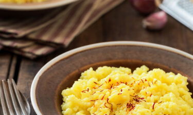 Italian risotto alla Milanese with saffron is shown.