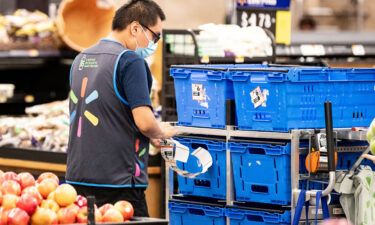 Walmart drops mask mandate for vaccinated employees. A Walmart employee here wears a mask as he works in Burbank
