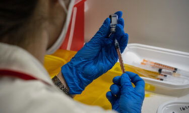 A nurse prepares syringes with the Pfizer coronavirus booster vaccination on January 20 in Tokyo