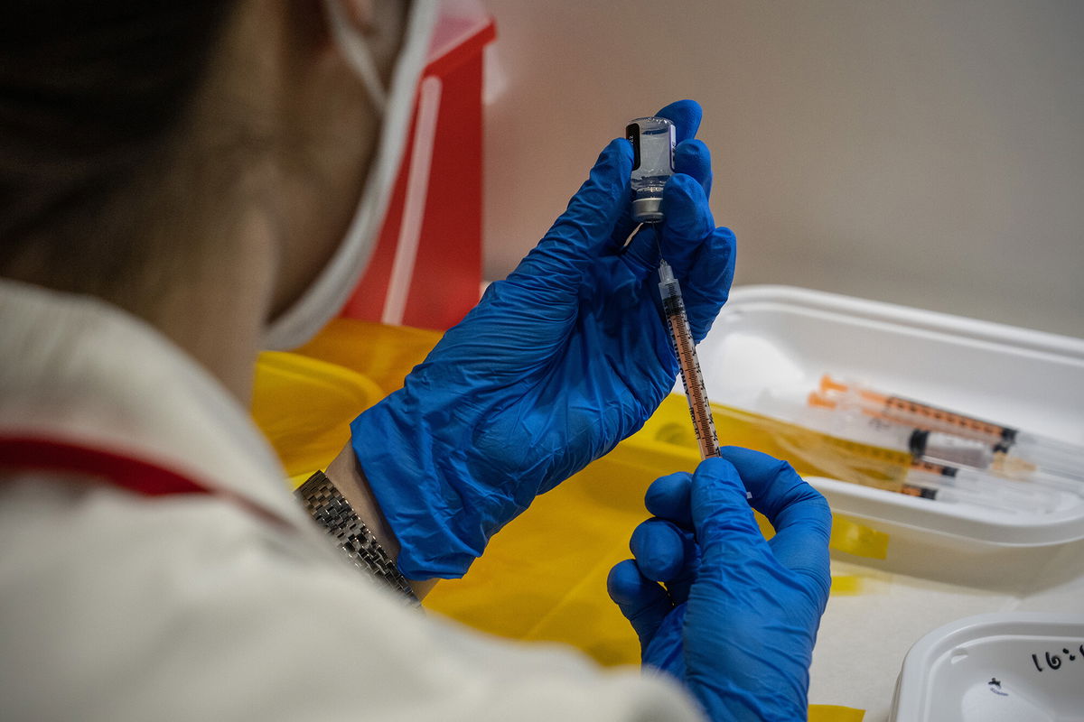 <i>Carl Court/Getty Images</i><br/>A nurse prepares syringes with the Pfizer coronavirus booster vaccination on January 20 in Tokyo