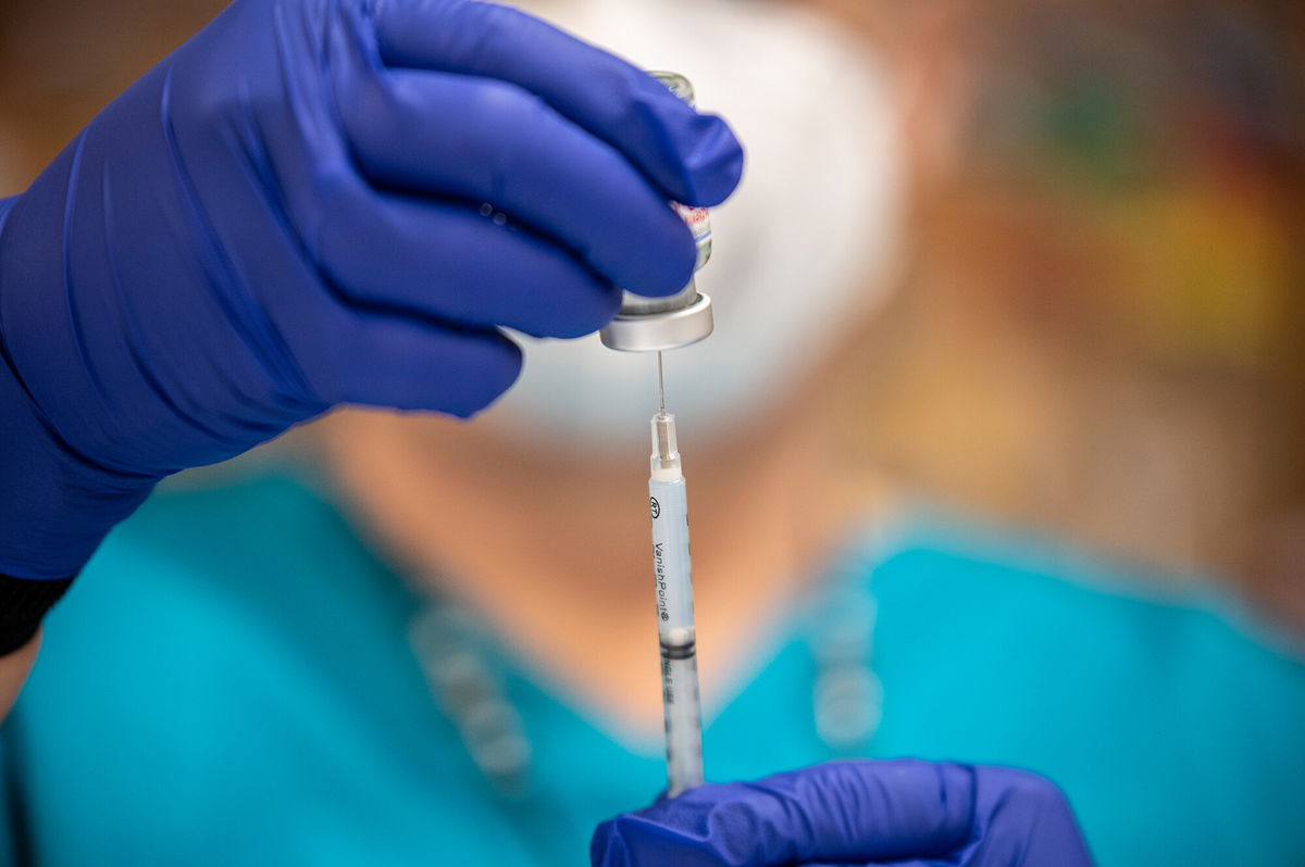 <i>Sergio Flores/Getty Images</i><br/>A nurse fills up a syringe with the Moderna Covid-19 vaccine at a vaccination site at a senior center on March 29