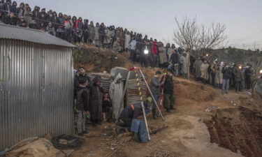 Residents watch in concern as civil defense and local authorities dig in a hill as they attempt to rescue a 5 year old boy who fell into a hole near the town of Bab Berred near Chefchaouen