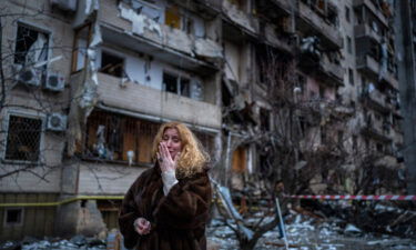 Natali Sevriukova reacts next to her house following a rocket attack on Kyiv on Friday