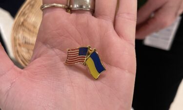 Capitol staffer handed out Ukraine-US flag pins to lawmakers attending Zelensky's address at the Capitol on March 16.