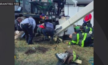 Braintree firefighters rescued a man who was trapped under bucket truck.