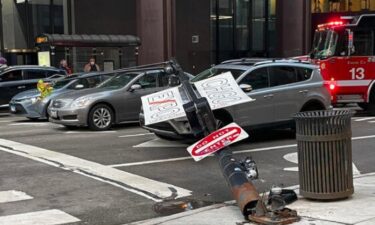 The base of the light pole was visibly rusted out as it lay on its side between two orange cones at Columbus Drive and Grand Avenue