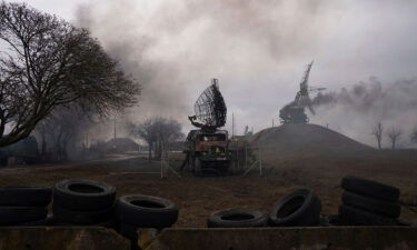 Smoke rises from an air defense base in the aftermath of an apparent Russian strike in Mariupol on February 24.