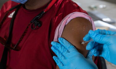 A patient receives a booster dose of the Pfizer-BioNTech coronavirus vaccine in Southfield