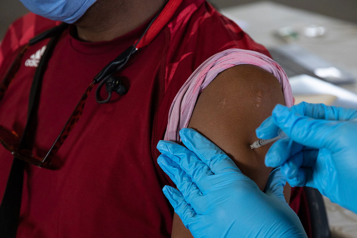 <i>Emily Elconin/Getty Images</i><br/>A patient receives a booster dose of the Pfizer-BioNTech coronavirus vaccine in Southfield