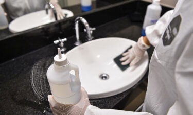 A member of the cleaning team disinfects a room at the Vivenzo hotel on April 7