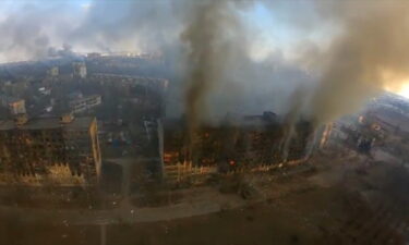 Smoke rises from damaged residential buildings on March 14 in Mariupol