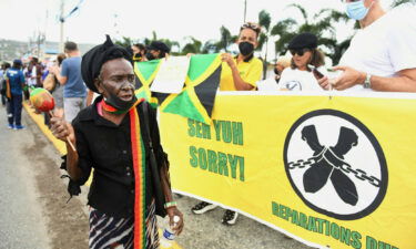 People call for slavery reparations outside the entrance of the British High Commission during the visit of the Duke and Duchess of Cambridge in Kingston