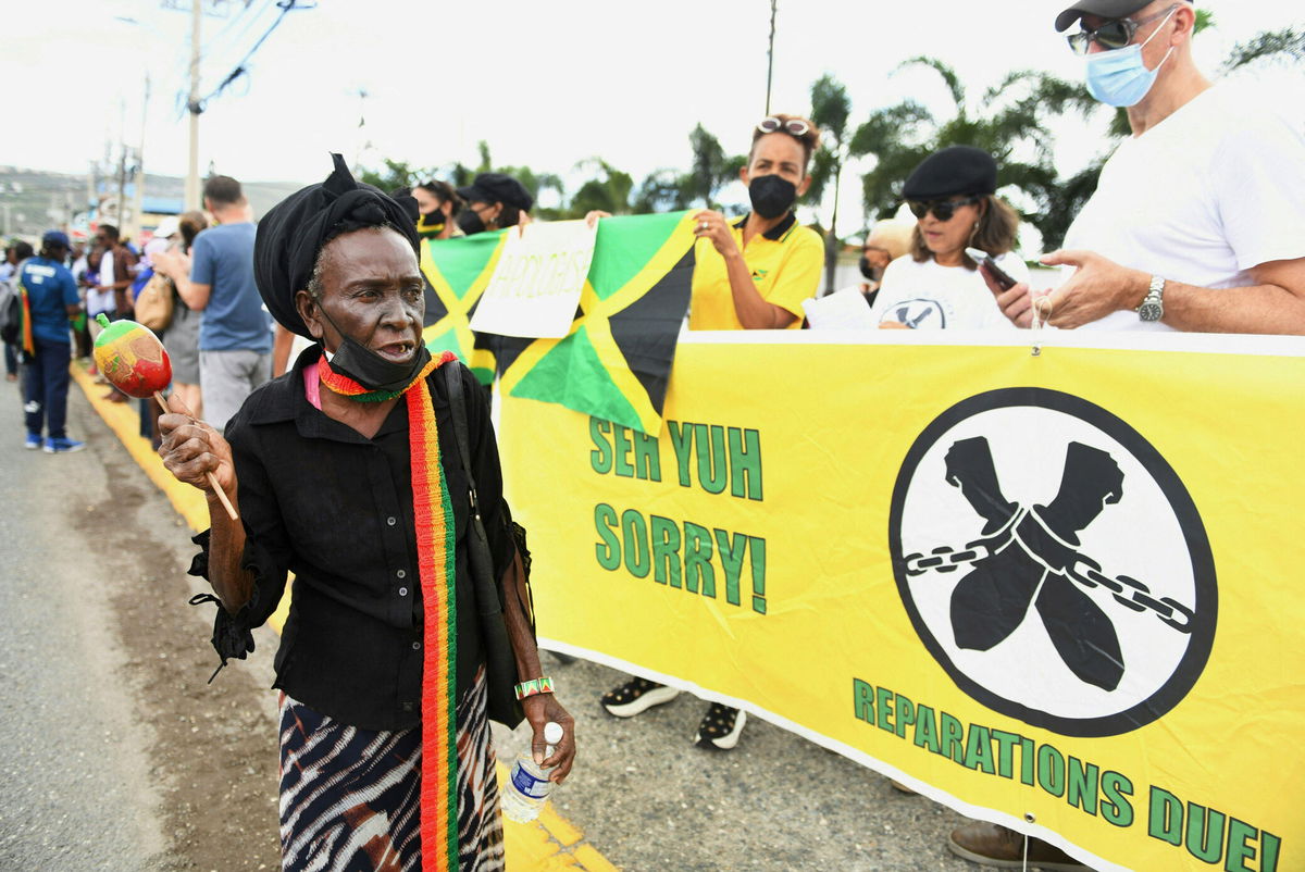 <i>RICARDO MAKYN/AFP/Getty Images</i><br/>People call for slavery reparations outside the entrance of the British High Commission during the visit of the Duke and Duchess of Cambridge in Kingston