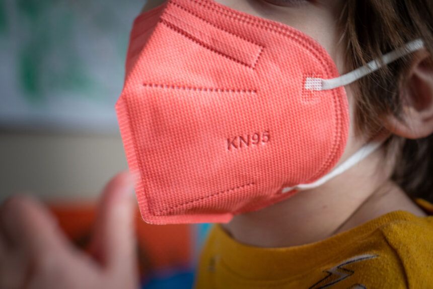 A child wears a KN95 mask.