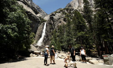 Visitors admire Yosemite Falls in 2020 in Yosemite National Park