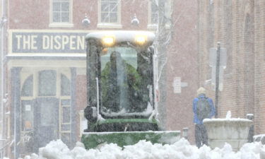 A city worker plows the sidewalk near Lancaster's Central Market Saturday in Lancaster