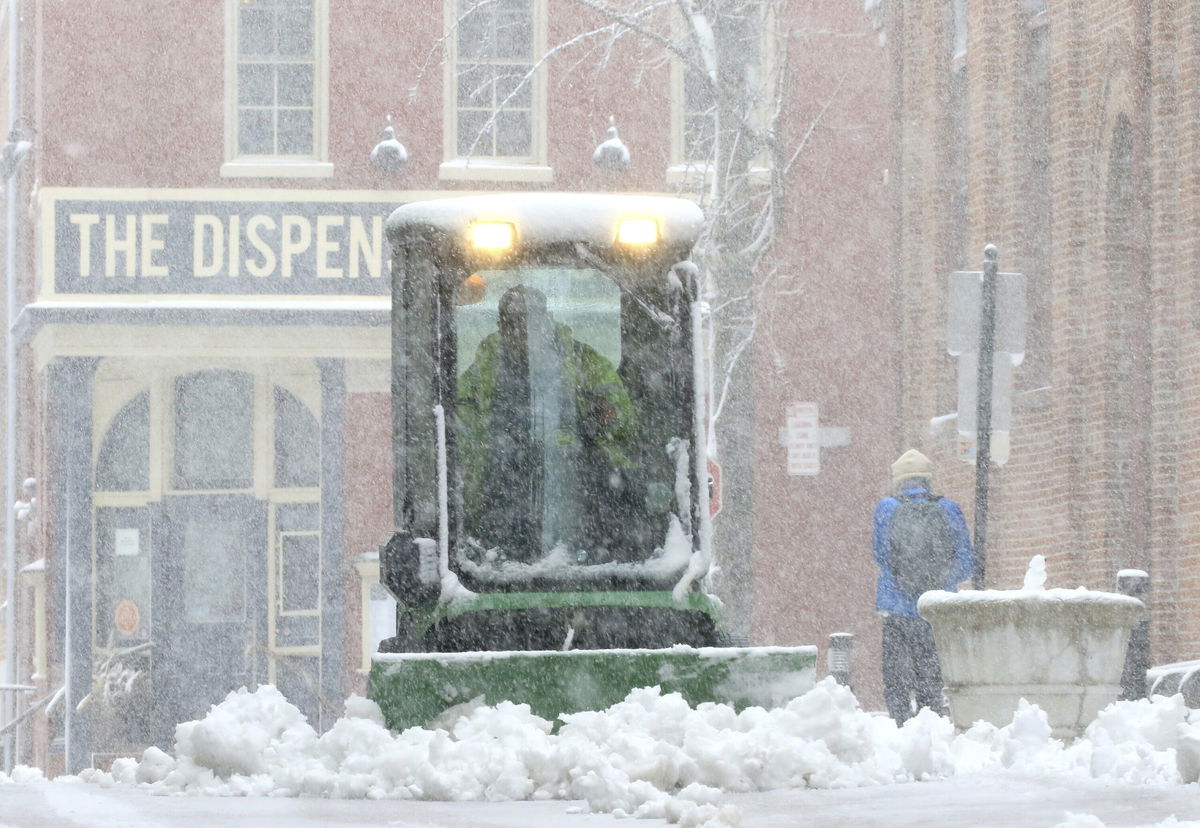 <i>Jim Gerberich/AP</i><br/>A city worker plows the sidewalk near Lancaster's Central Market Saturday in Lancaster