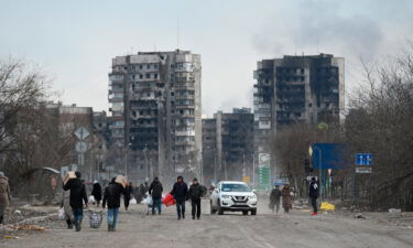 Refugees carrying their personal belongings leave Mariupol. While some have been able to leave