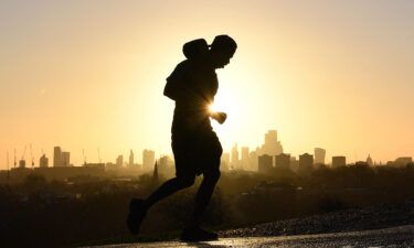 A jogger runs up Primrose Hill in London on February 17. A full-body workout like running or swimming burns the most calories.