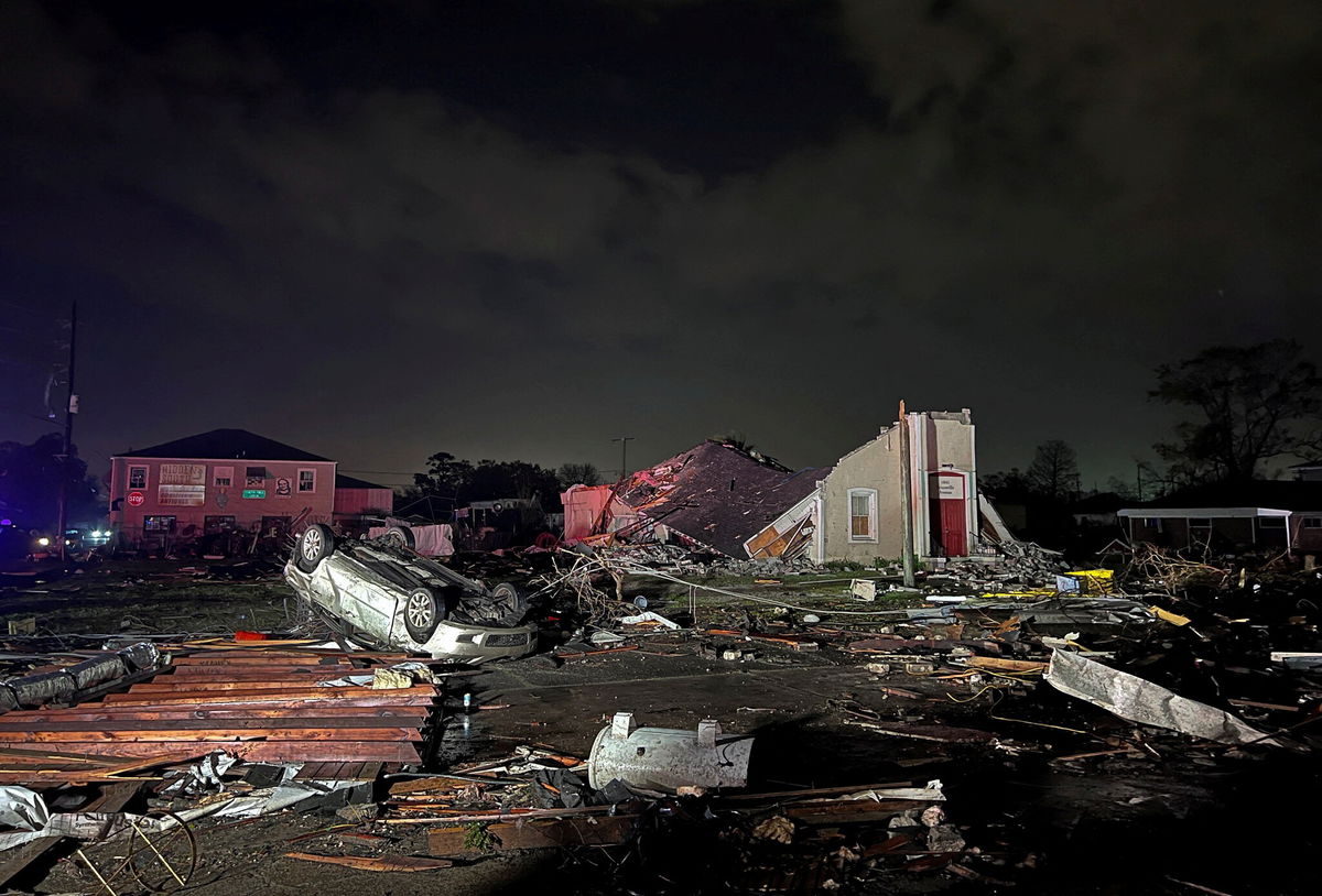 <i>Reuters</i><br/>A car lies overturned among debris in Arabi