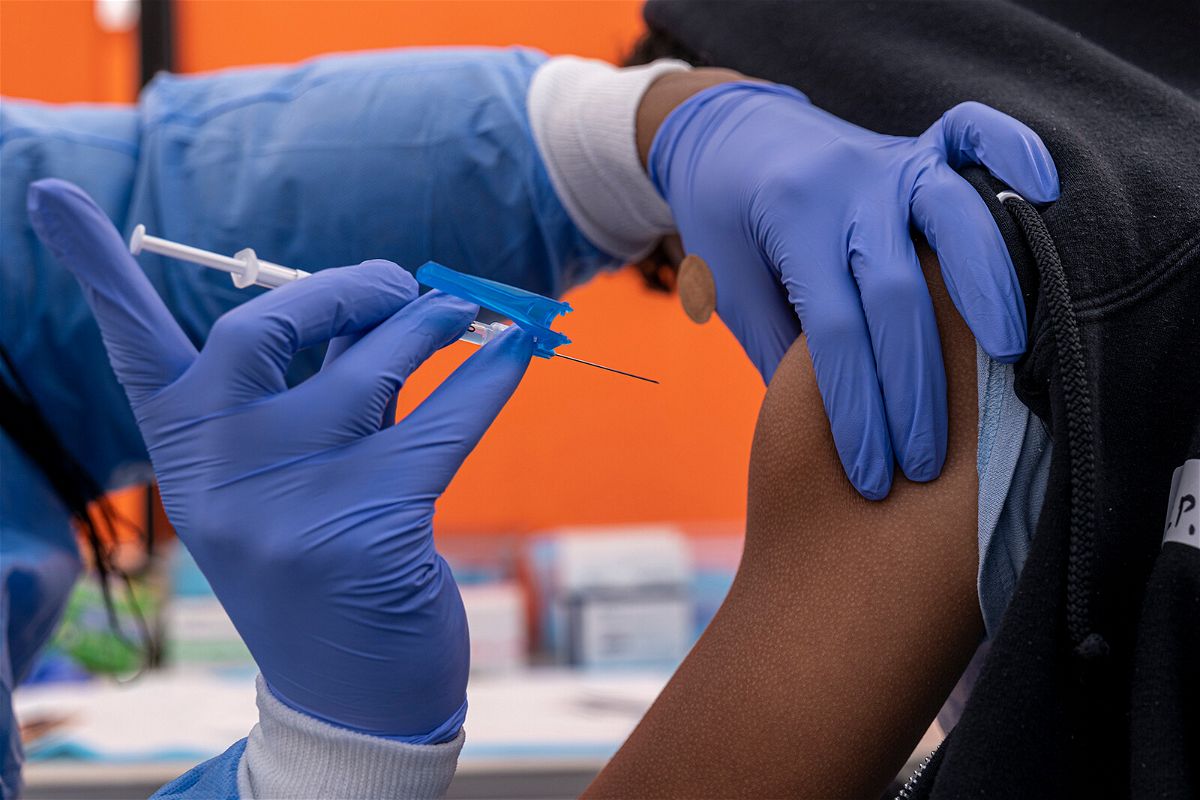 <i>David Paul Morris/Bloomberg/Getty Images</i><br/>A healthcare worker administers a Pfizer-BioNTech Covid-19 vaccine to a child at a testing and vaccination site in San Francisco