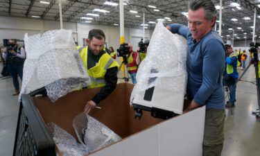 California Gov. Gavin Newsom helps pack medical supplies bound for Ukraine at the Office of Emergency Services warehouse in Dixon