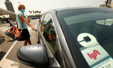 A traveler connects with a driver at the Rideshare Lot at LAX Airport on Aug. 20