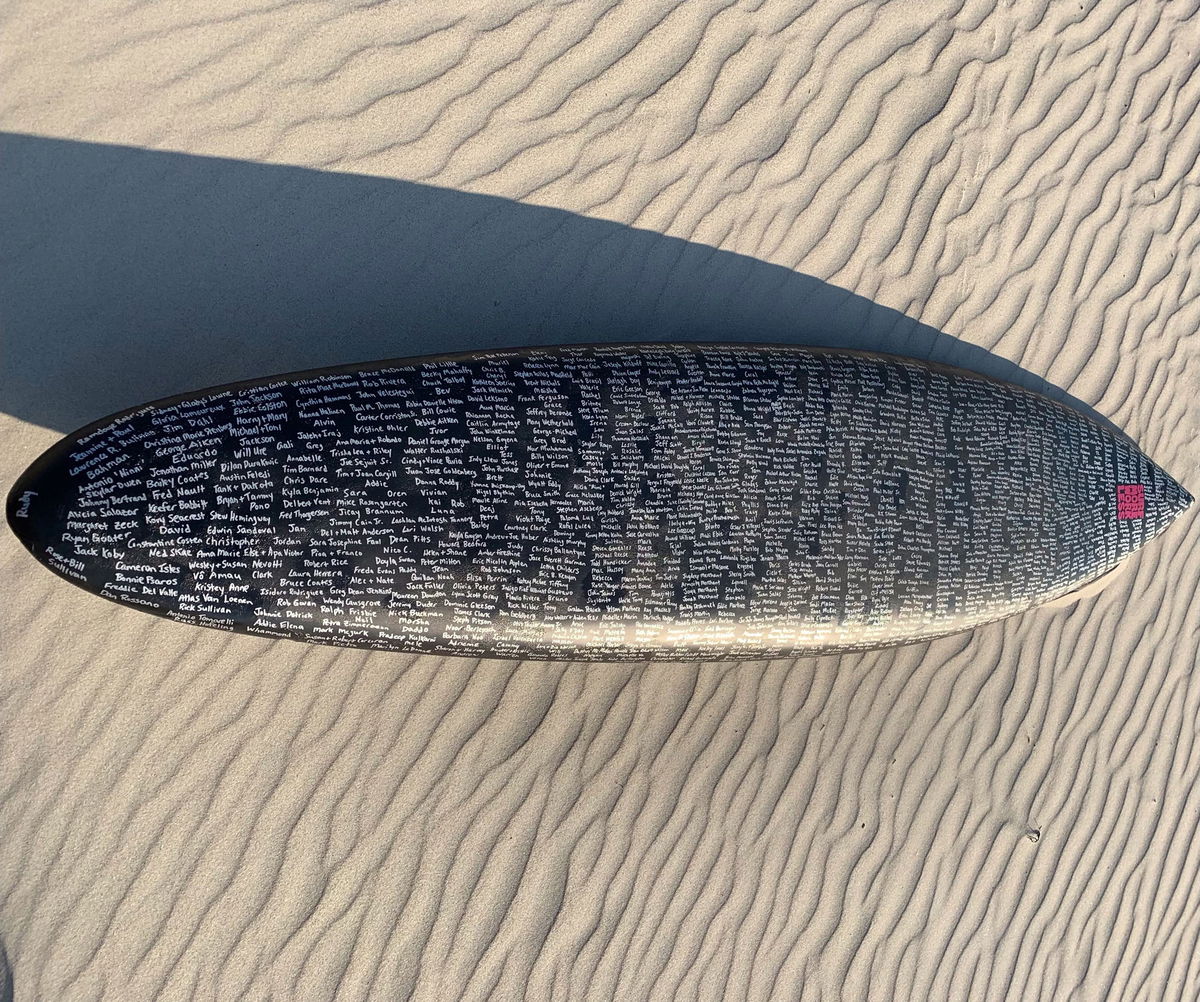 	Fischer's surfboards are covered with hundreds of names of departed loved  ones.