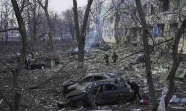 Ukrainian emergency employees work at the hospital damaged by shelling in Mariupol.