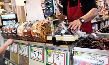 A clerk weighs dried peppers for a customer inside a store in downtown Los Angeles on March 11.
