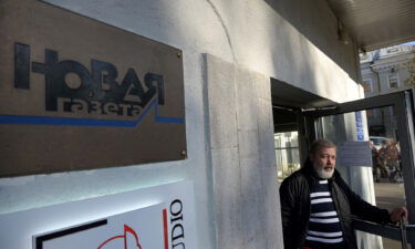 Novaya Gazeta editor Dmitry Muratov is seen at the entrance to the office of the Novaya Gazeta newspaper in Moscow in October 2021. The Novaya Gazeta is suspending publication until the end of the war in Ukraine.