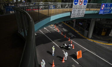 Transit officers control access to a tunnel in the direction of a district in lockdown as a measure against Covid-19 in Shanghai on March 28. Covid fears are rocking the oil market.