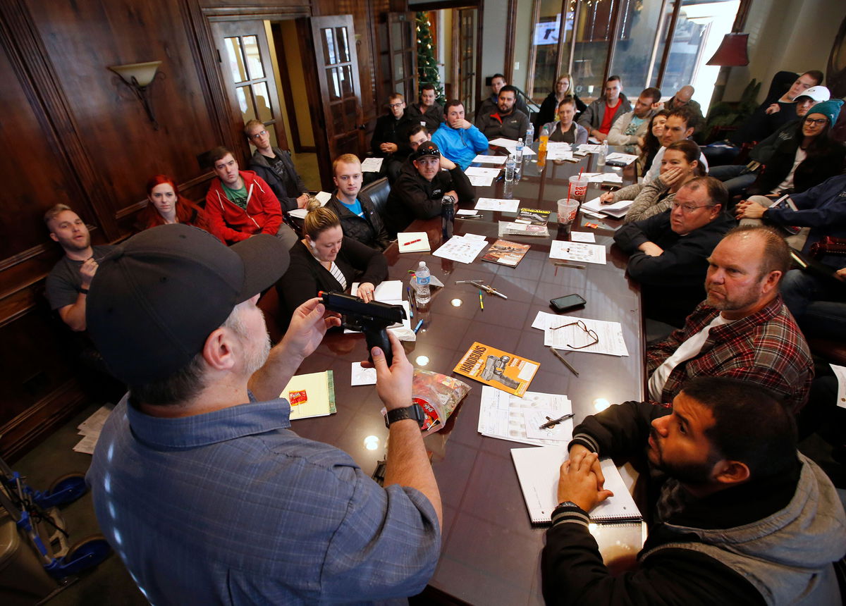 <i>George Frey/Getty Images</i><br/>Damon Thueson teaches a packed gun concealed carry permit class put on by 