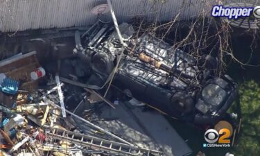 A single-car crash left a police vehicle flipped over in the backyard of a homeowner.