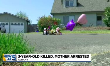 Neighbors started a memorial on the driveway outside the home with flowers