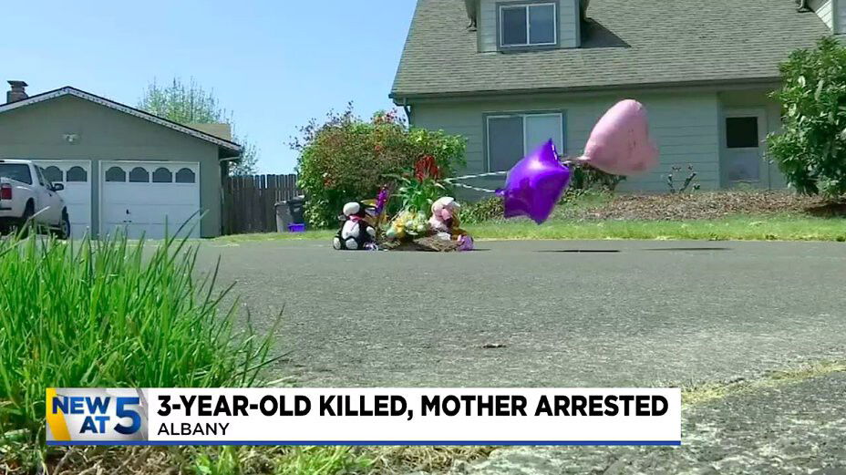 <i>KPTV</i><br/>Neighbors started a memorial on the driveway outside the home with flowers