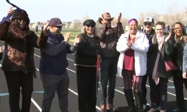 A high school teacher who kept her Olympic gold medals a secret from her students was honored with new a track.