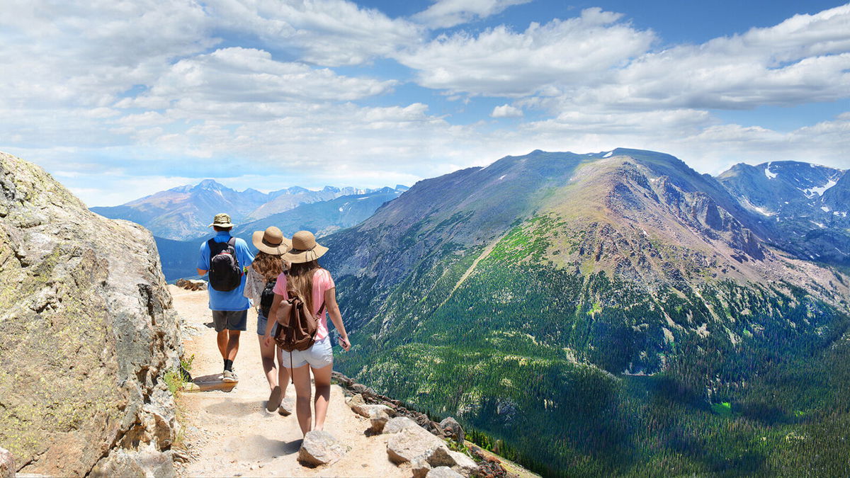 <i>Margaret/Adobe Stock</i><br/>Father with his family enjoying time on a trip. Rocky Mountain National Park landscape