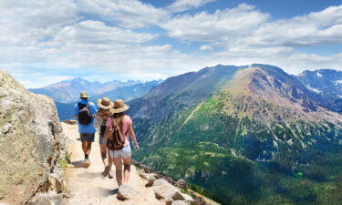 Father with his family enjoying time on a trip. Rocky Mountain National Park landscape