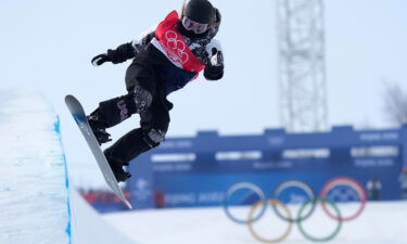 Chloe Kim performing a trick during the Women's Snowboard Halfpipe Final at the Beijing 2022 Winter Olympics.